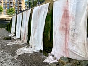 Installation view of Mary Lemley's banners on the Thames foreshore